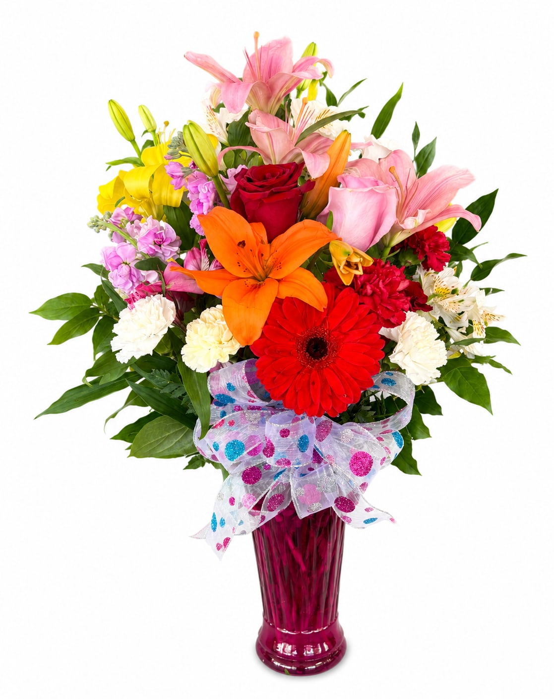 Colorful bouquet of lilies, roses, gerbera daisies, and carnations in a pink vase