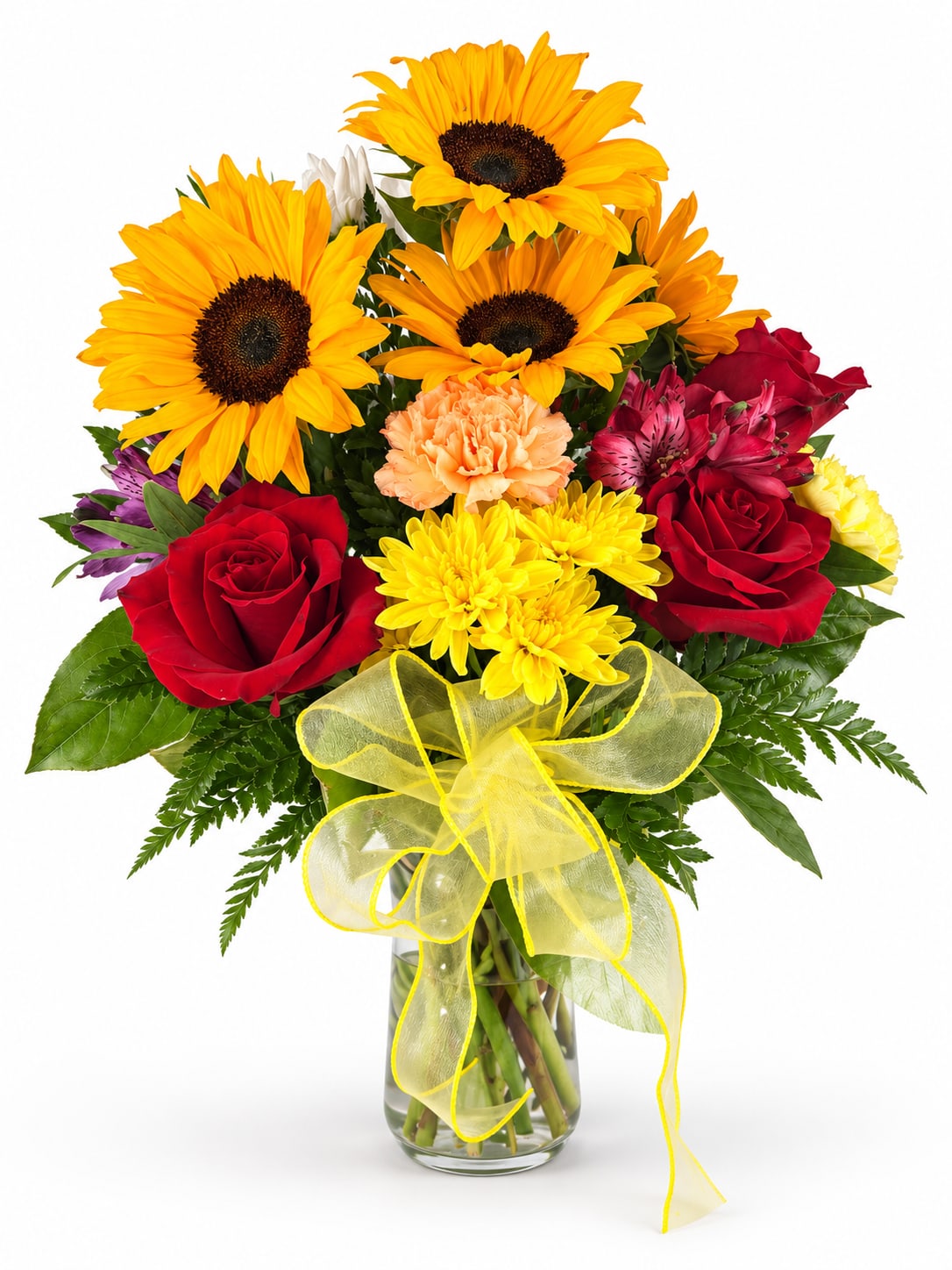 Bouquet of sunflowers, red roses, and mixed blooms in a glass vase with a yellow ribbon