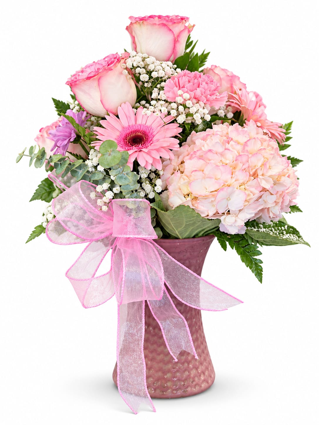 Pink and white bouquet in a textured vase with a pink ribbon