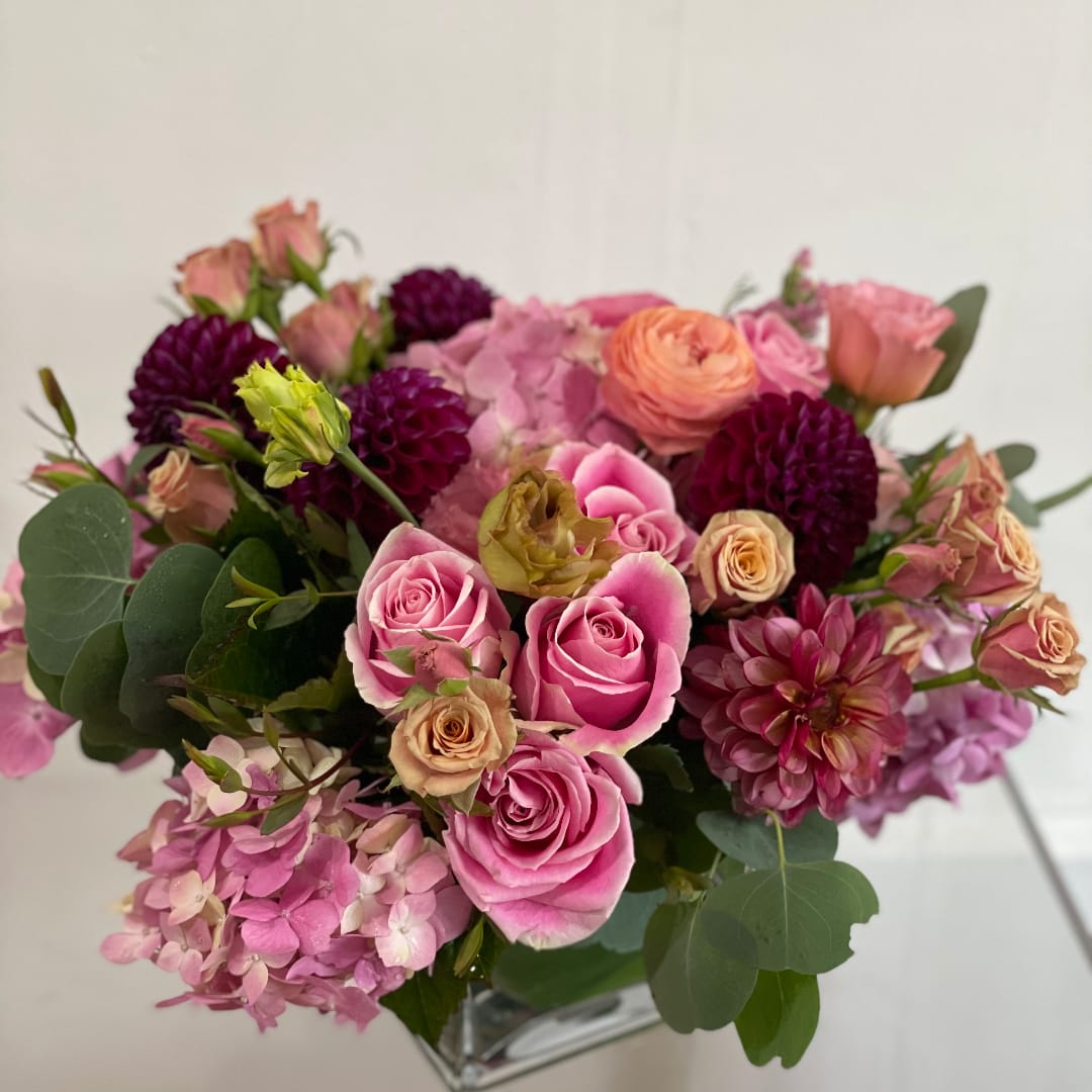 Love spell - Designers Choice mixed blooms in soft pinks and deep reds, arranged by our designers for an enchanting, feminine look perfect for anniversaries or surprise bouquets.