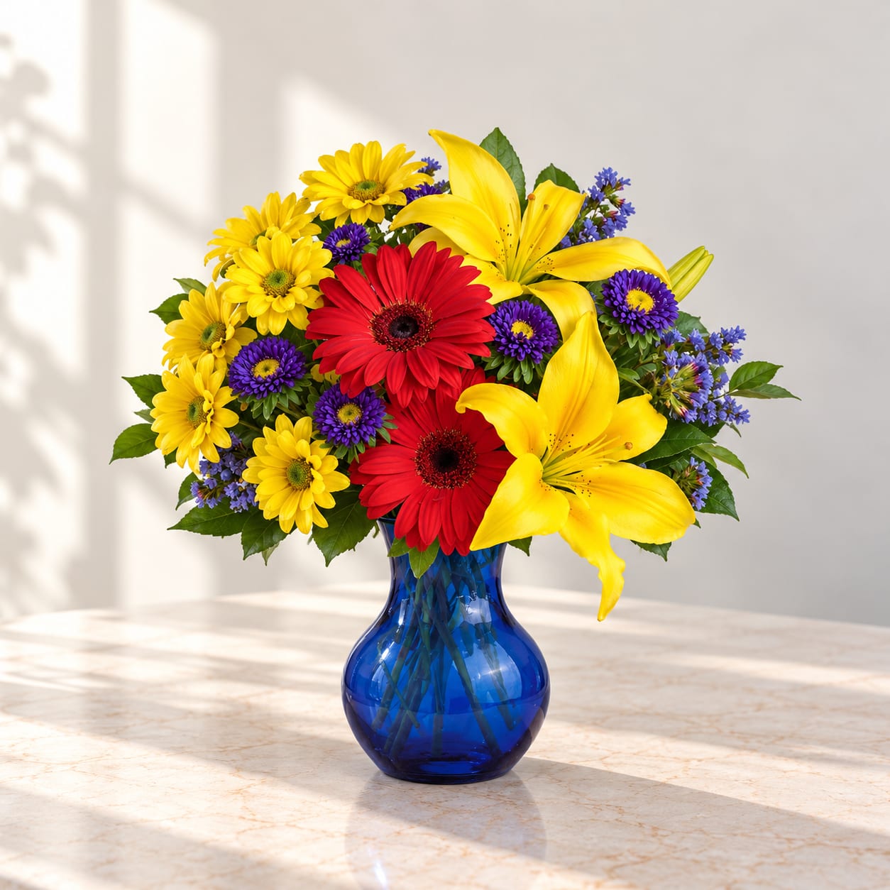 Colorful bouquet of yellow daisies, red gerberas, and yellow lilies in a blue vase