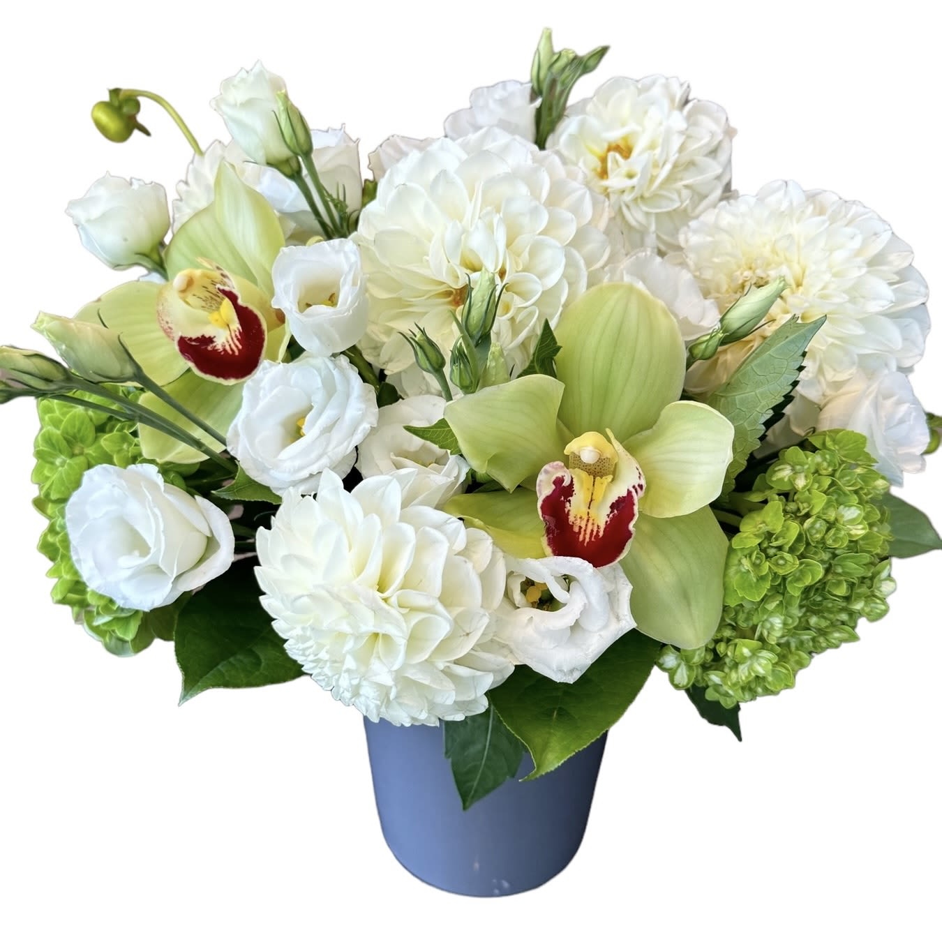 Elegant Essence  - All white dahlias, lisianthus, green hydrangea, and cymbidium orchids designed in a grey glass vase. As shown.