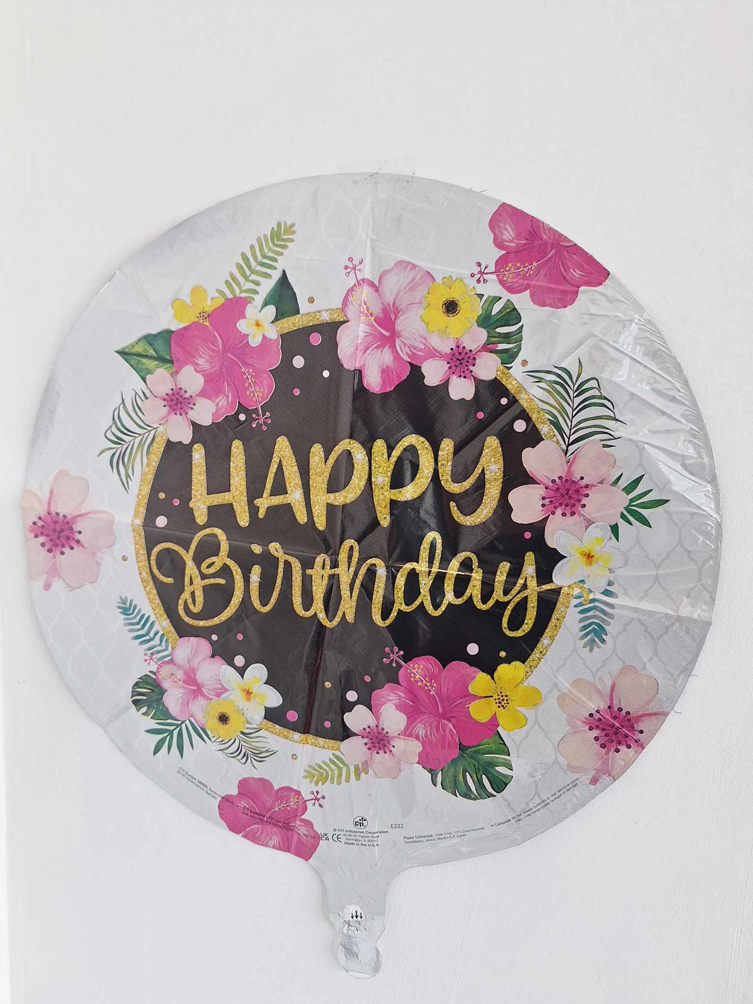 Round birthday balloon with pink and yellow floral print