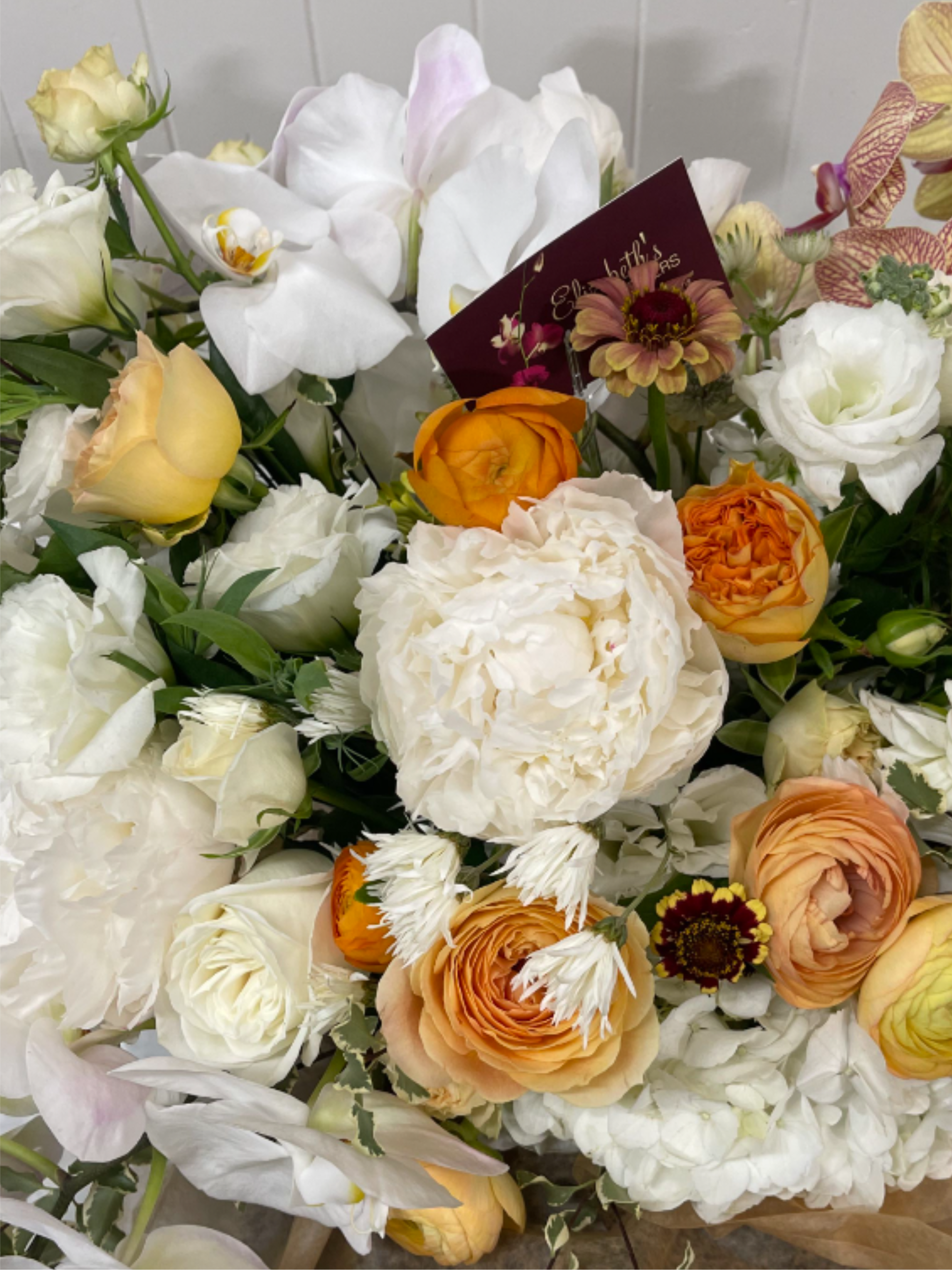 Designer's Choice - Fall Into Winter - Floral arrangement focusing on whites and creams with touches of seasonal fall hues - yellows, orange, peach, magenta, fuchsia, burgundy, etc.  Each Designer's Choice vase arrangement will be one of a kind and consist of fresh, seasonal flowers. The arrangement depicted in the photo is just one example of our Designer's Choice - Fall design. Actual arrangement may vary in terms of flower type, color scheme, and overall design depending on seasonal and local availability - but will be similar in size and include flowers of equal value.  Standard - 6"x6"  Vase Deluxe - 6.5"x6.5" Vase Premium - 7"x7" Vase 