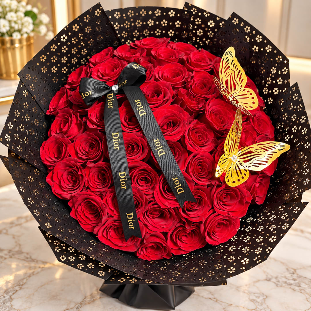 Bouquet of red roses wrapped in black paper with butterfly decorations