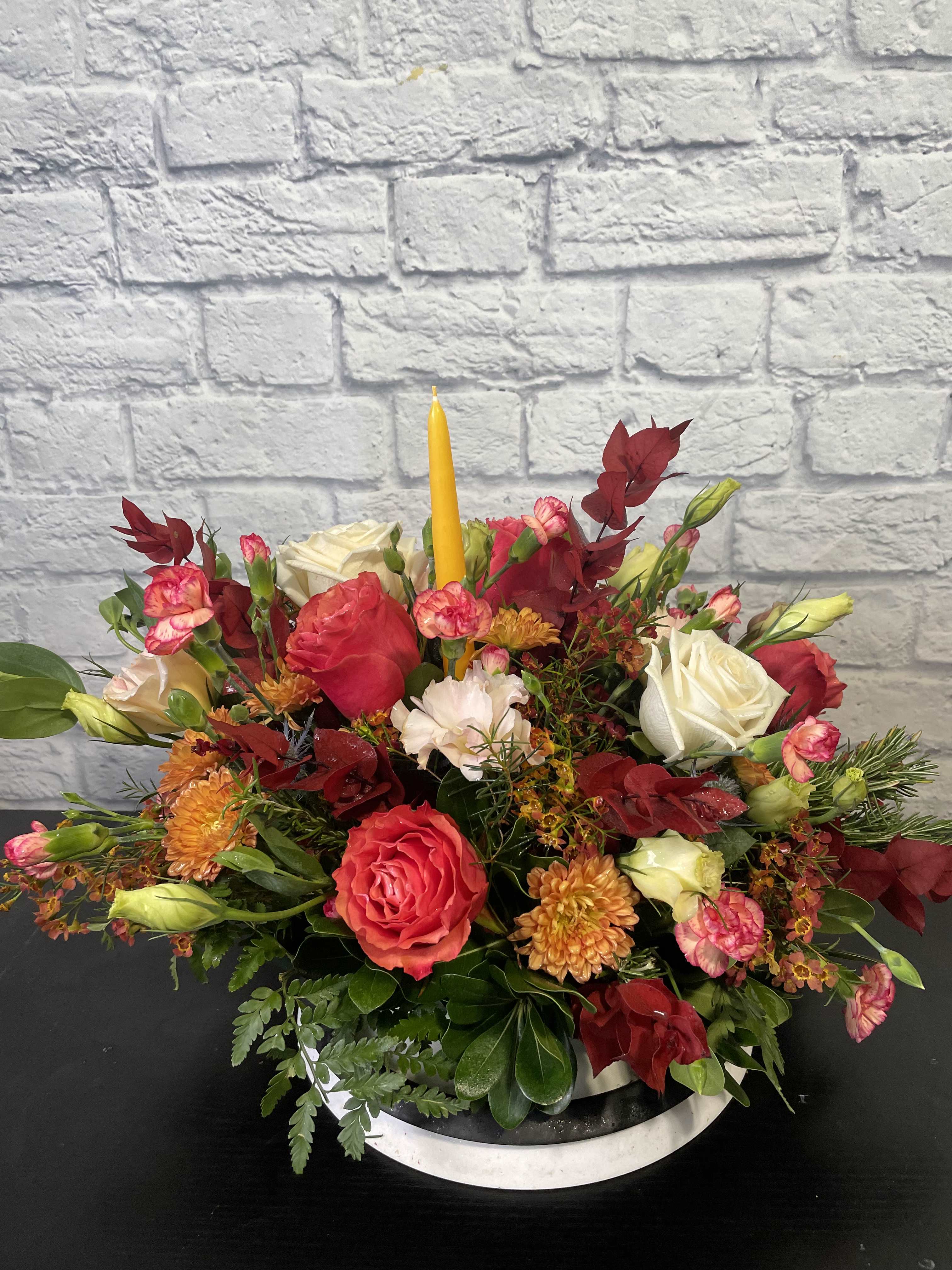 Thanksgiving Center Piece - Are you hosting Thanksgiving this year? This center piece is for you! This bouquet is full of fall flowers and colors. It will leave every one speechless and asking where you got it!  Flowers type and Vase may vary depending on inventory. We love to give our artists the ability to design as they please. Includes a candle.   We have 3 sizes to choose from.  The STANDARD is smaller in size for a smaller table (around 13" x 13" x 16"), DELUXE is our medium regular size for the average table (around 23" x 13" x 18"), and the PREMIUM is for a food table of a larger table or area (around 33" x 13" x 20").  These are all short in height.  They may come with a candle or without depending on preference and look.  They will come rounded, so all sides will see the flowers.  This will totally impression your hostess or guests this holiday season.  Delivery and pick up available.  