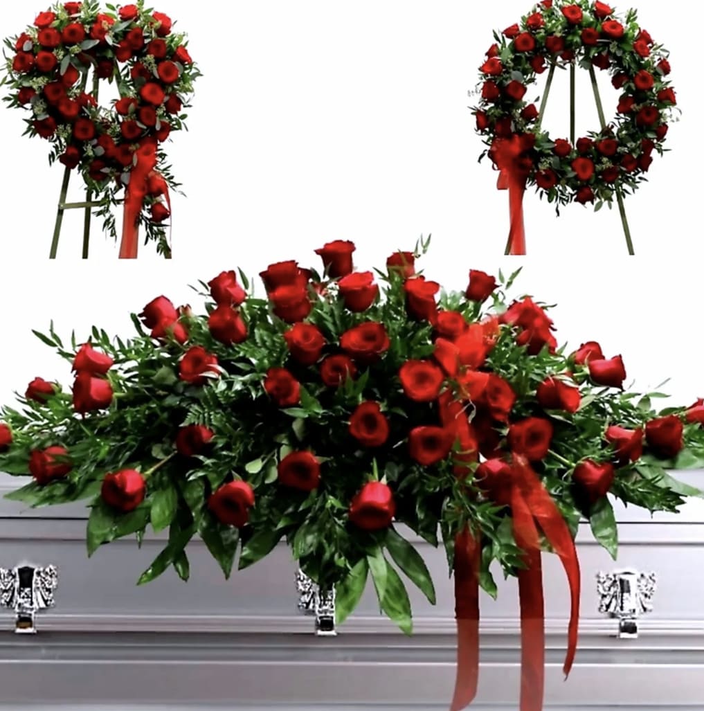 Red rose casket spray with ribbon accents