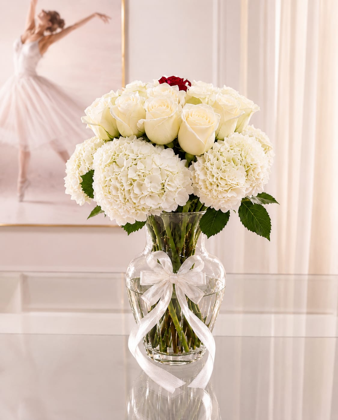 White Beauty - A white bouquet is a quite symphony of elegance- a delicate gathering of blooms that speaks in the language of purity, peace, and timeless grace. Each flower, whether is white/ creamy rose, a pink/red rose, or a soft hydrangea, brings its own soul to the arrangement, yet blends in perfect harmony.  Together, they don't shout-they grow. The bouquet feels like a deep breath, light morning light through sheer curtains, like the hush of fresh snow before the world wakes. It's a gift not just of beauty, but of serenity- the gentle remind that stillness can be powerful, and softness, unforgettable.
