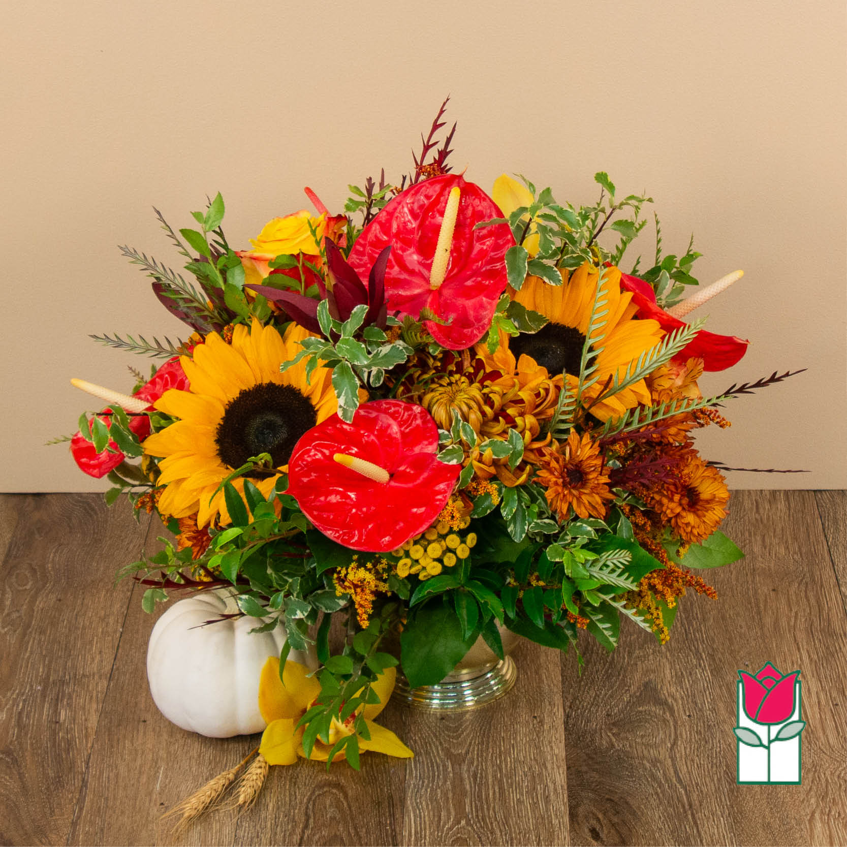 Bright mixed bouquet with sunflowers, red anthuriums, and autumn flowers in a vase