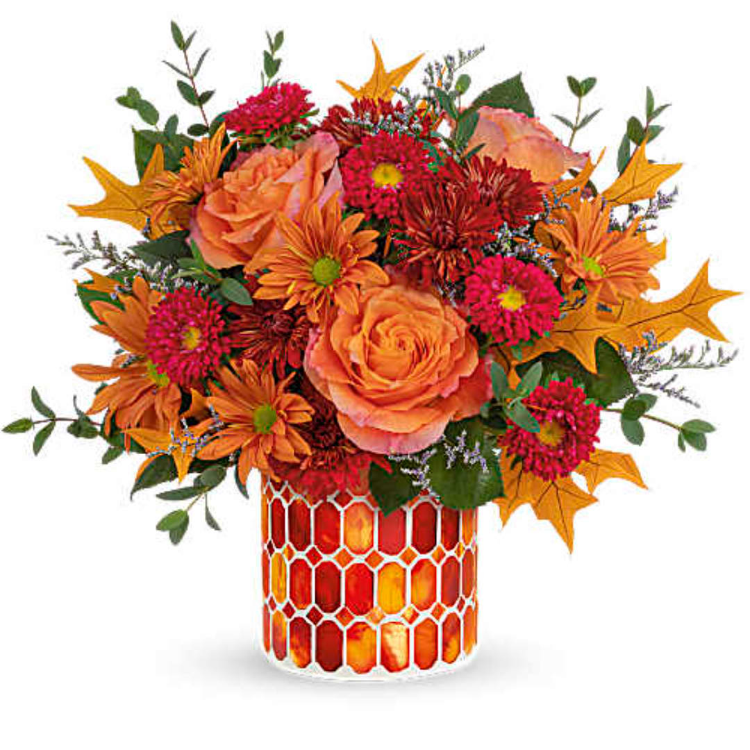 Orange and pink mixed bouquet in a mosaic glass vase