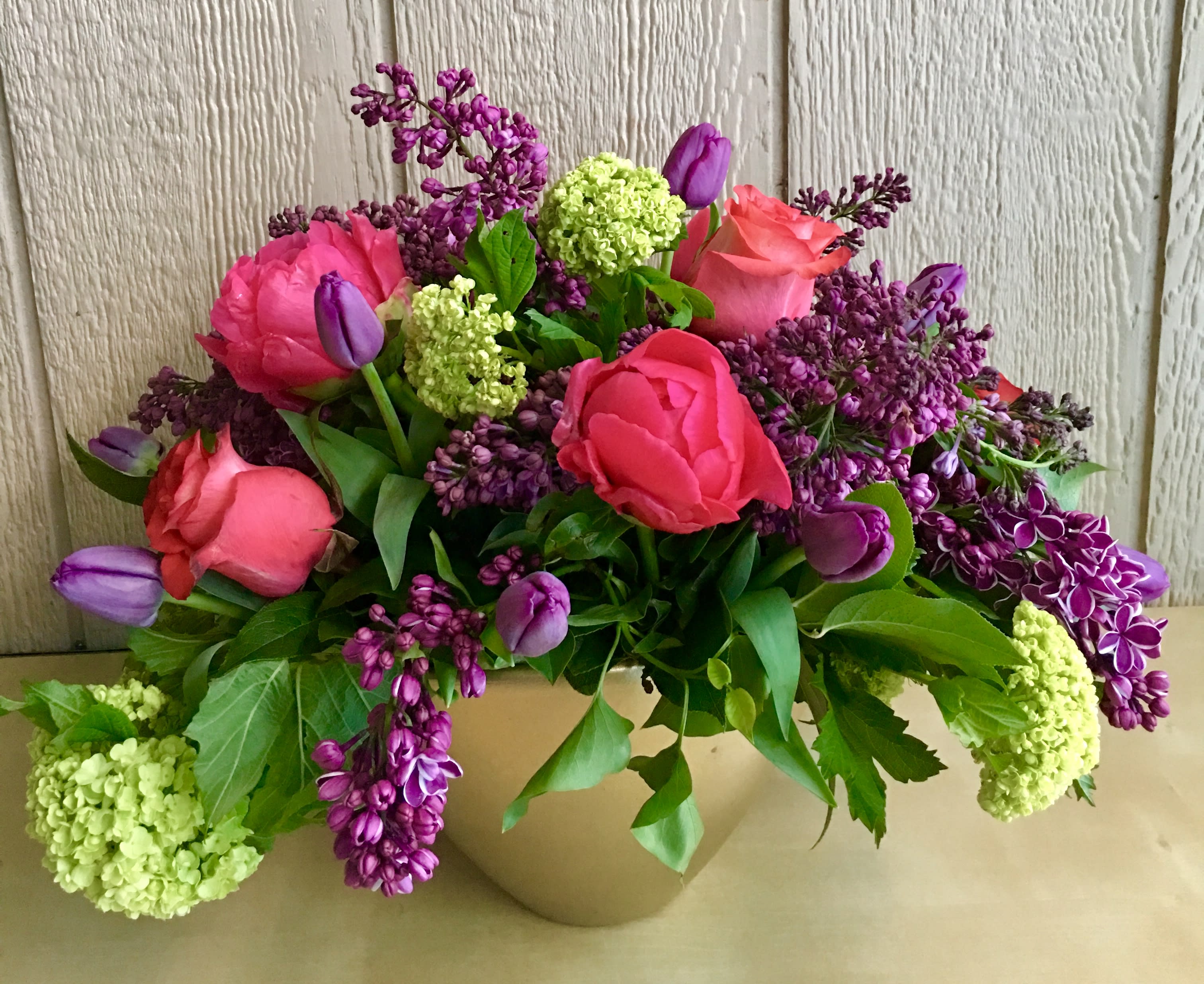 The Joy luck club - in a beautiful ceramic vase combination of flowers ( lilac, roses ,snow balls, roses, tulips ) arranged and will be delivered by Jane's roses of San Francisco