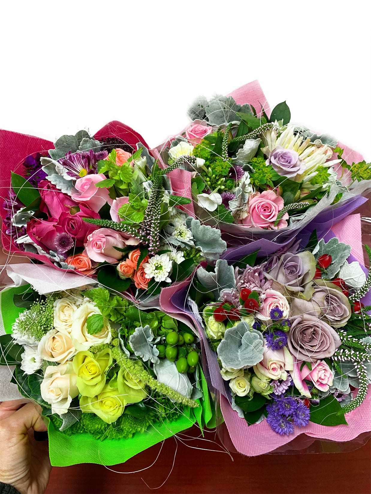 Assorted rose bouquets wrapped in colorful paper