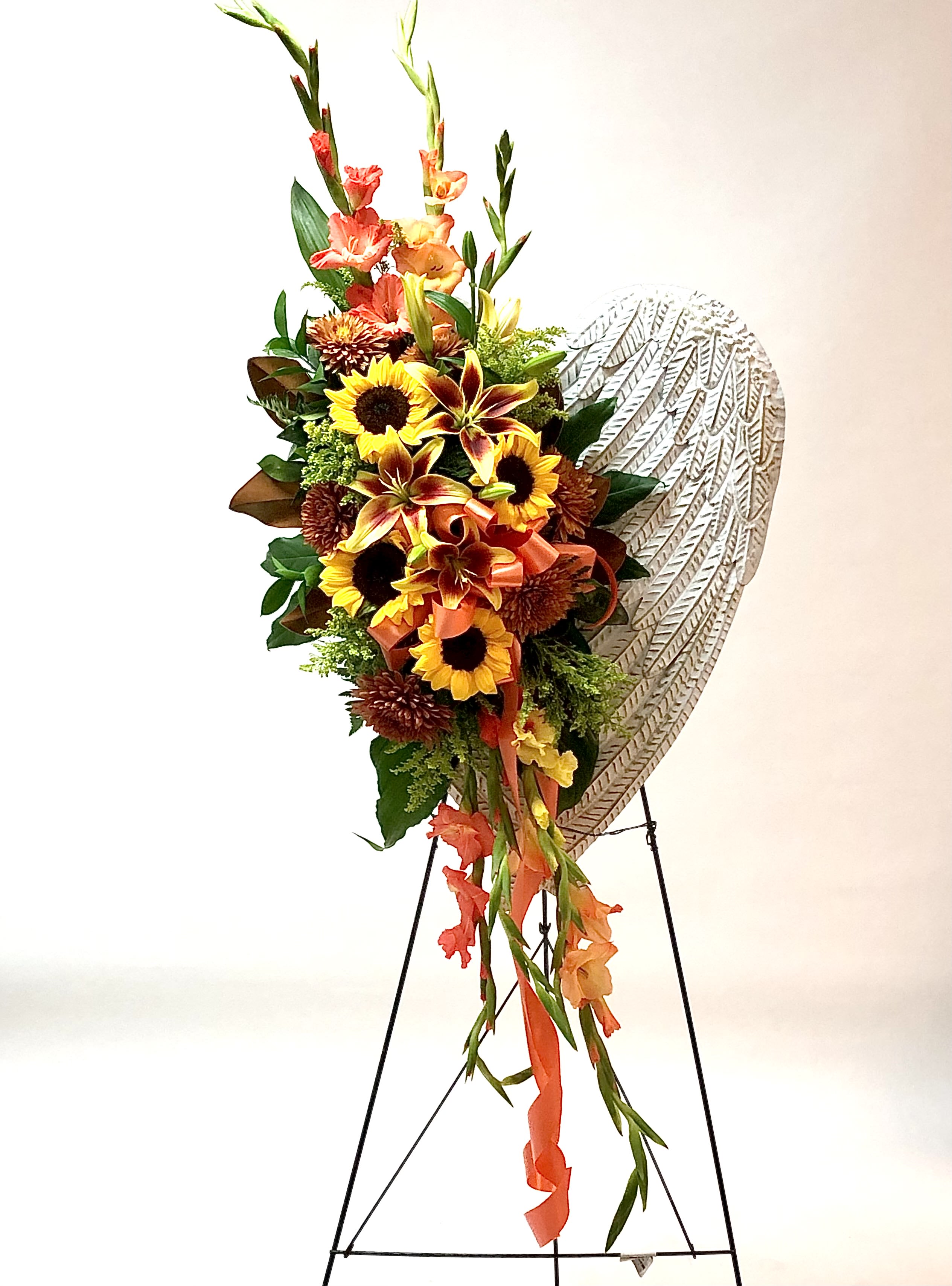 Sunflower Angel Wing Spray - Brighten up this sad moment with this beautiful Keepsake metal Angel wing spray can hang anywhere in your home or garden. Presented on an easel during service. 