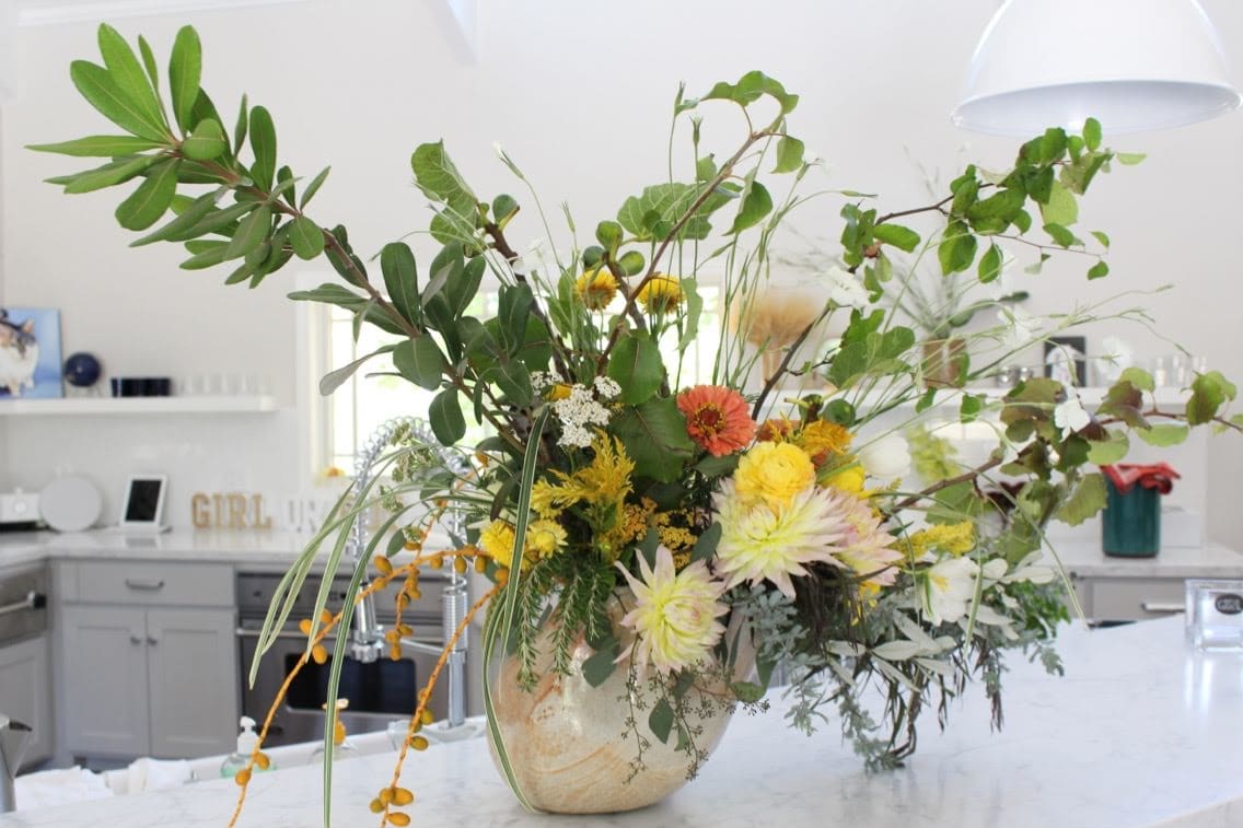 Verdant arrangement with yellow flowers