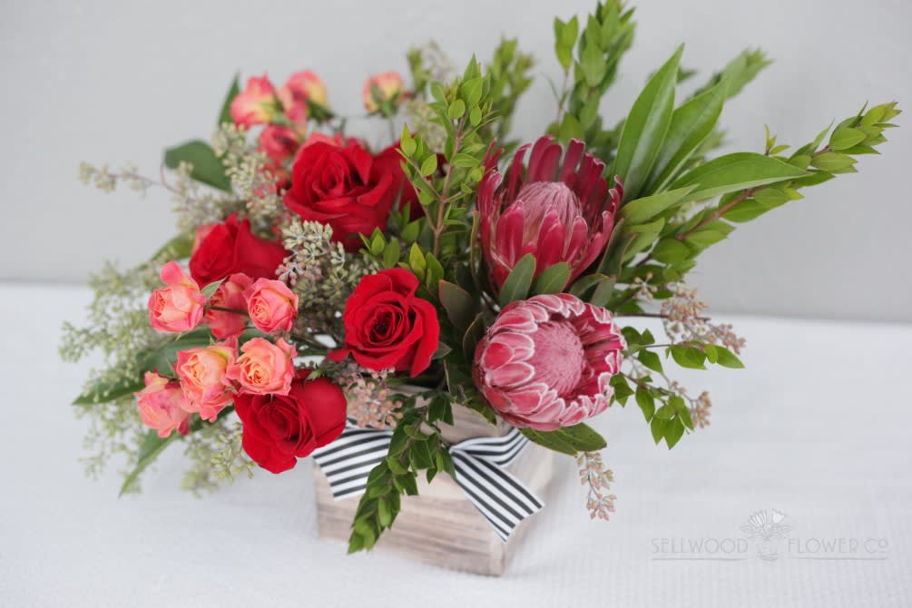 Modernity and tradition mix in this lively and sophisticated Valentines Day arrangement