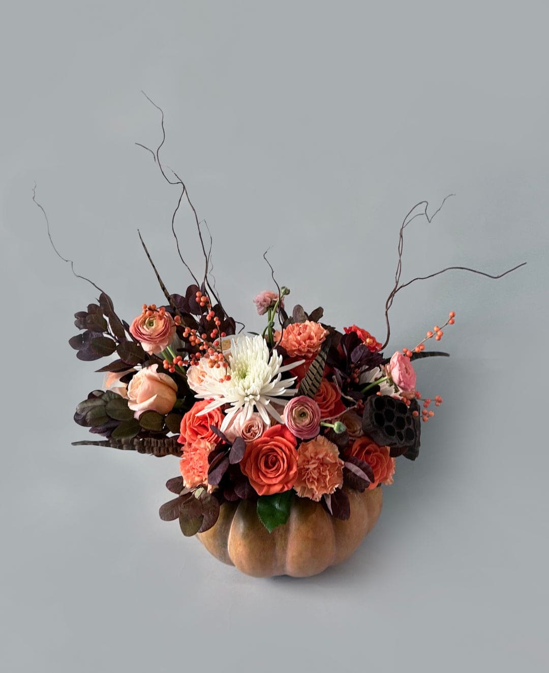 Floral pumpkin arrangement with coral roses and white chrysanthemums