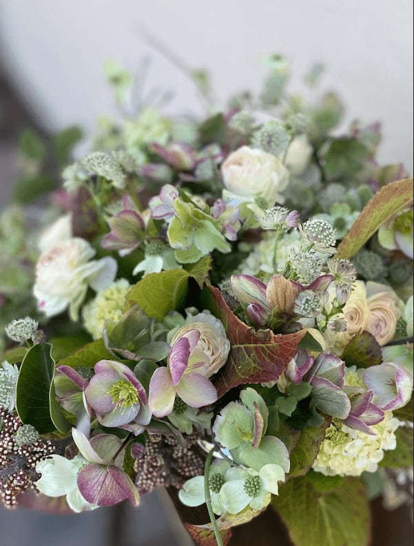 Floral arrangement with green and blush tones