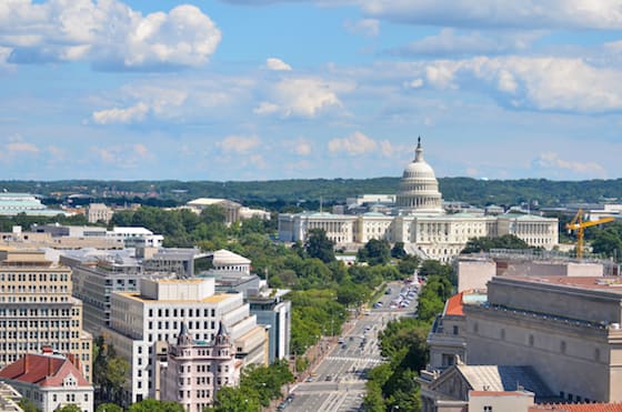 Aerial view of Pennsylvania street in Washington, DC featuring federal buildings, including the US Archives building, Department of Justice, and US Capitol.