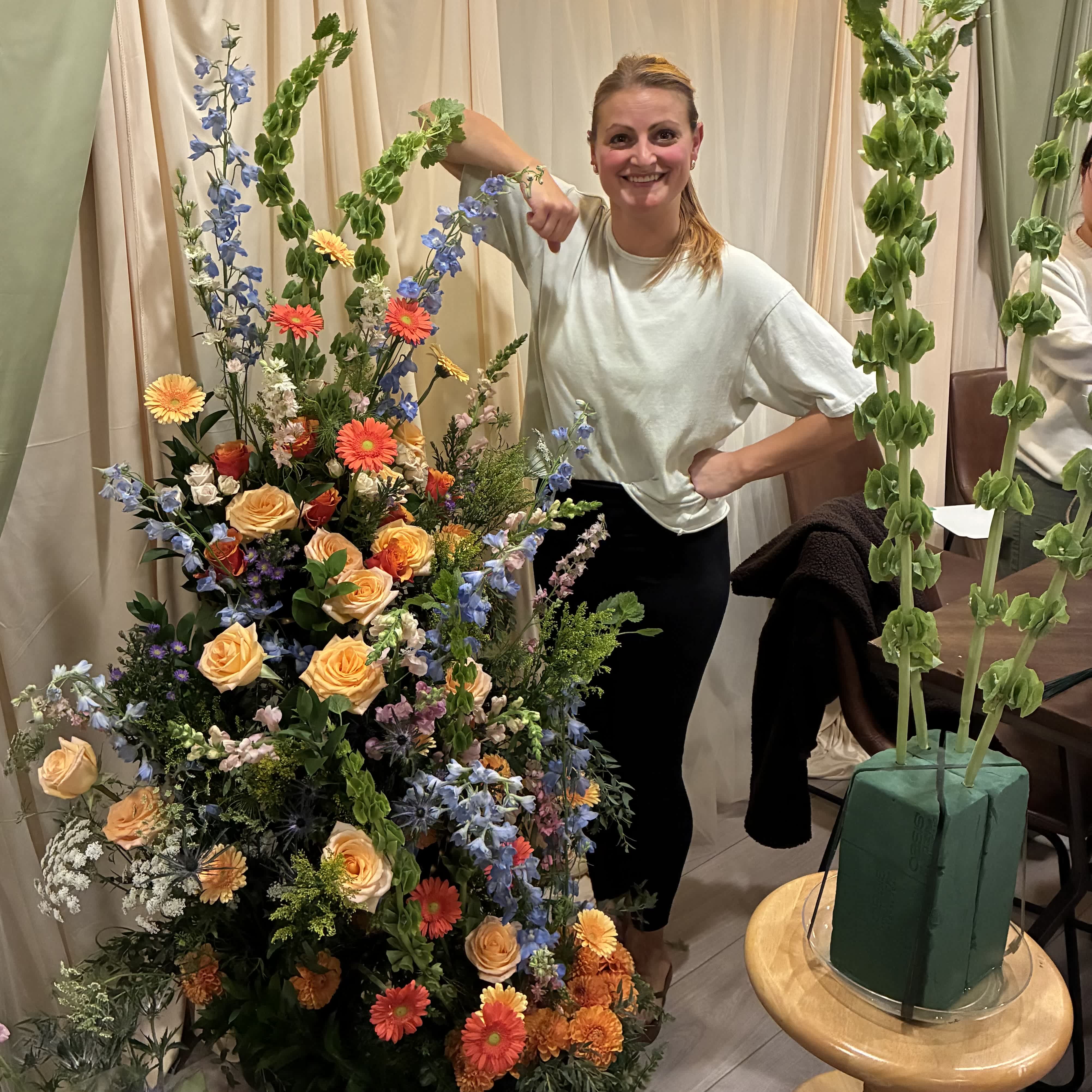 Anna designing large floral arrangements onsite at a wedding. Coady Florist wedding flowers.