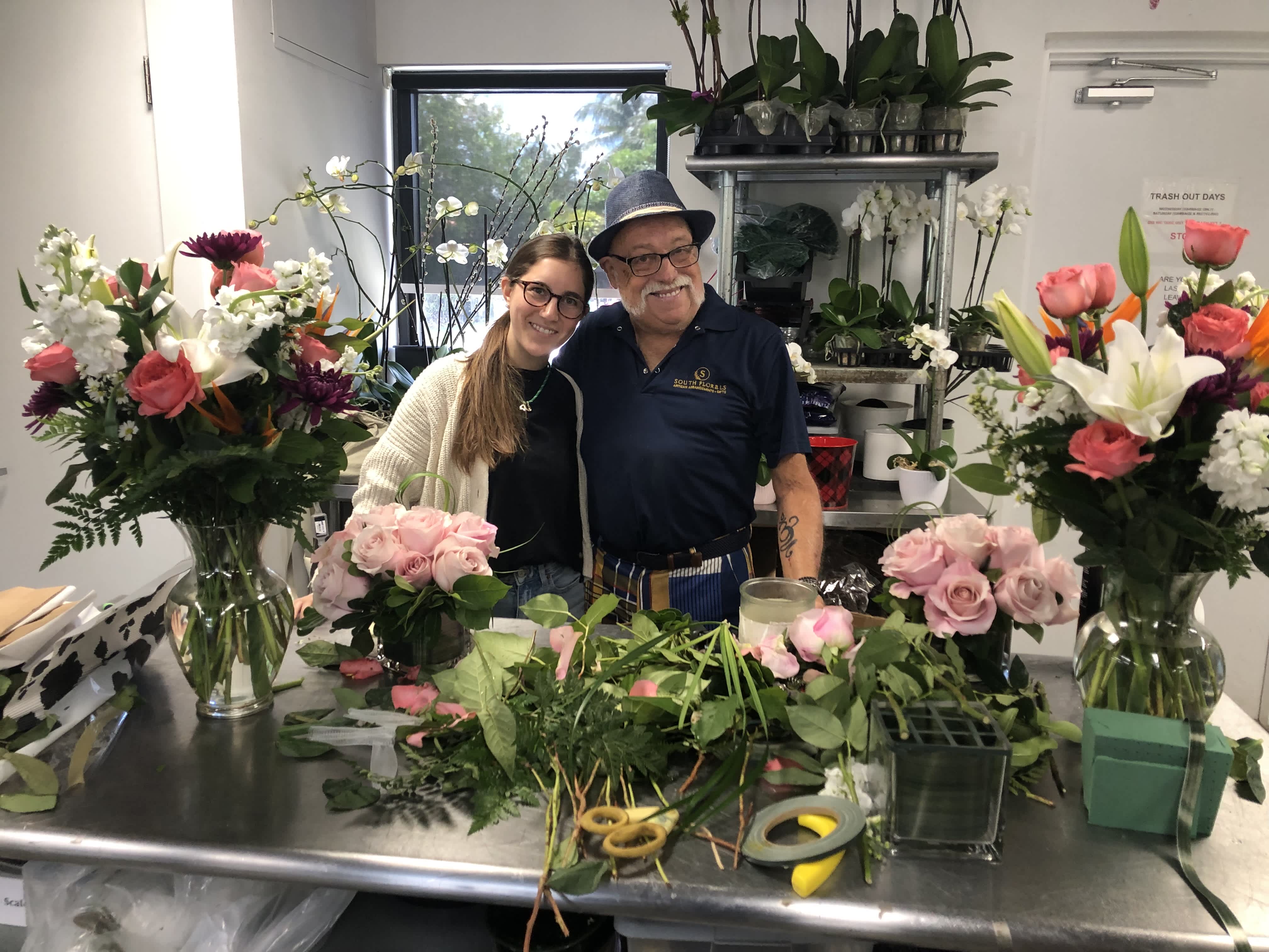 Woman and man surrounded by flowers