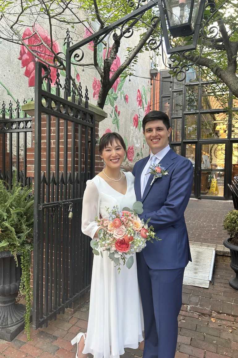 Newlyweds with bride holding a pink bouquet