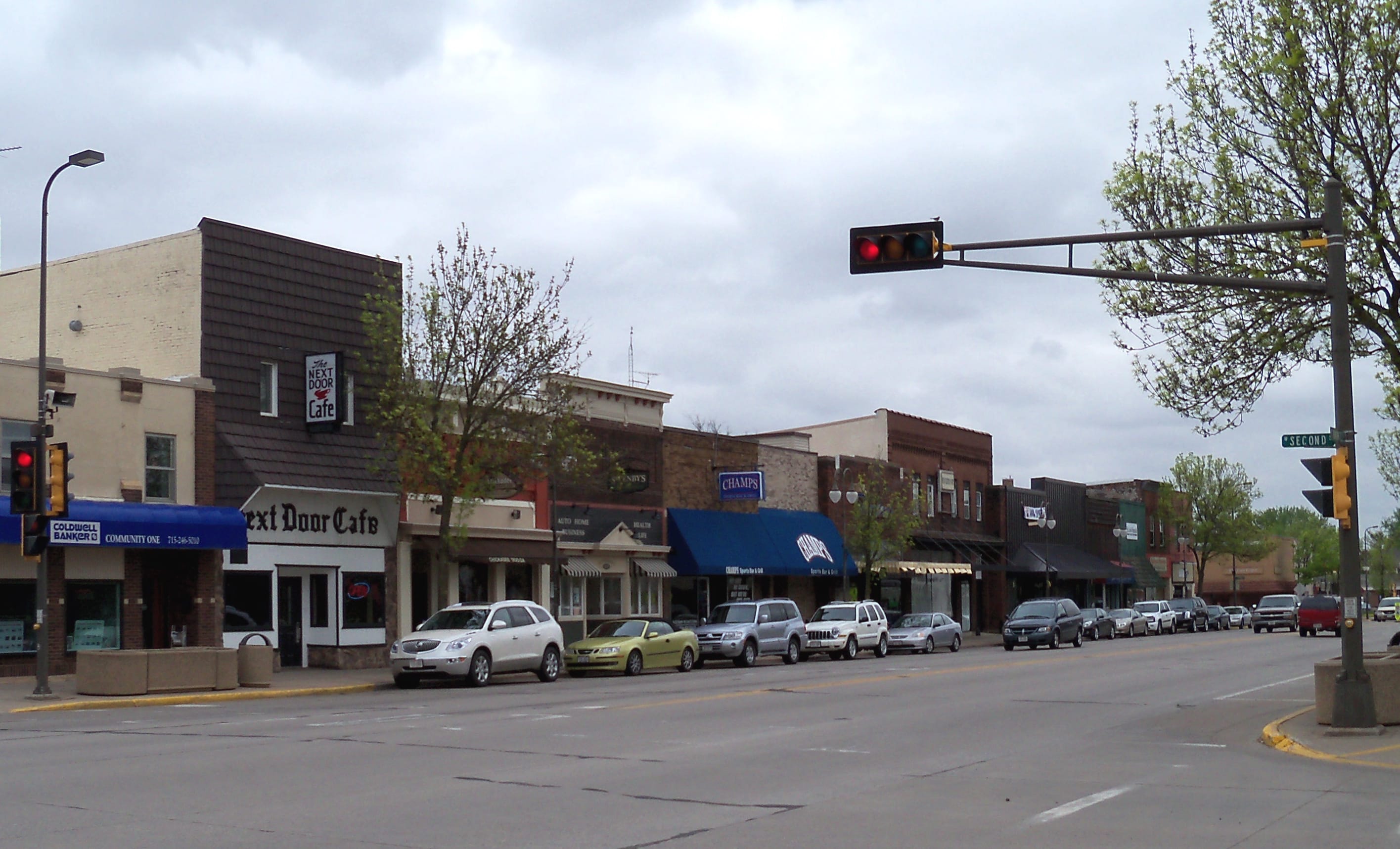 View of downtown New Richmond, Wisconsin with shops lining the street.