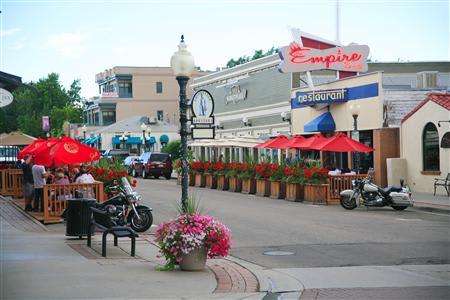 View of a main street in downtown Louisville, Colorado with restaurants and businesses lining the street.