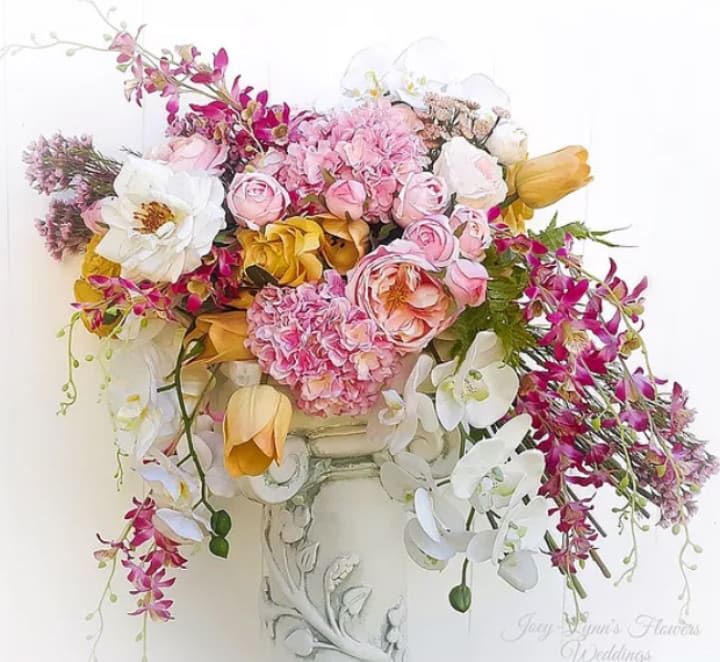 Peoneies, roses and orchid arrangement