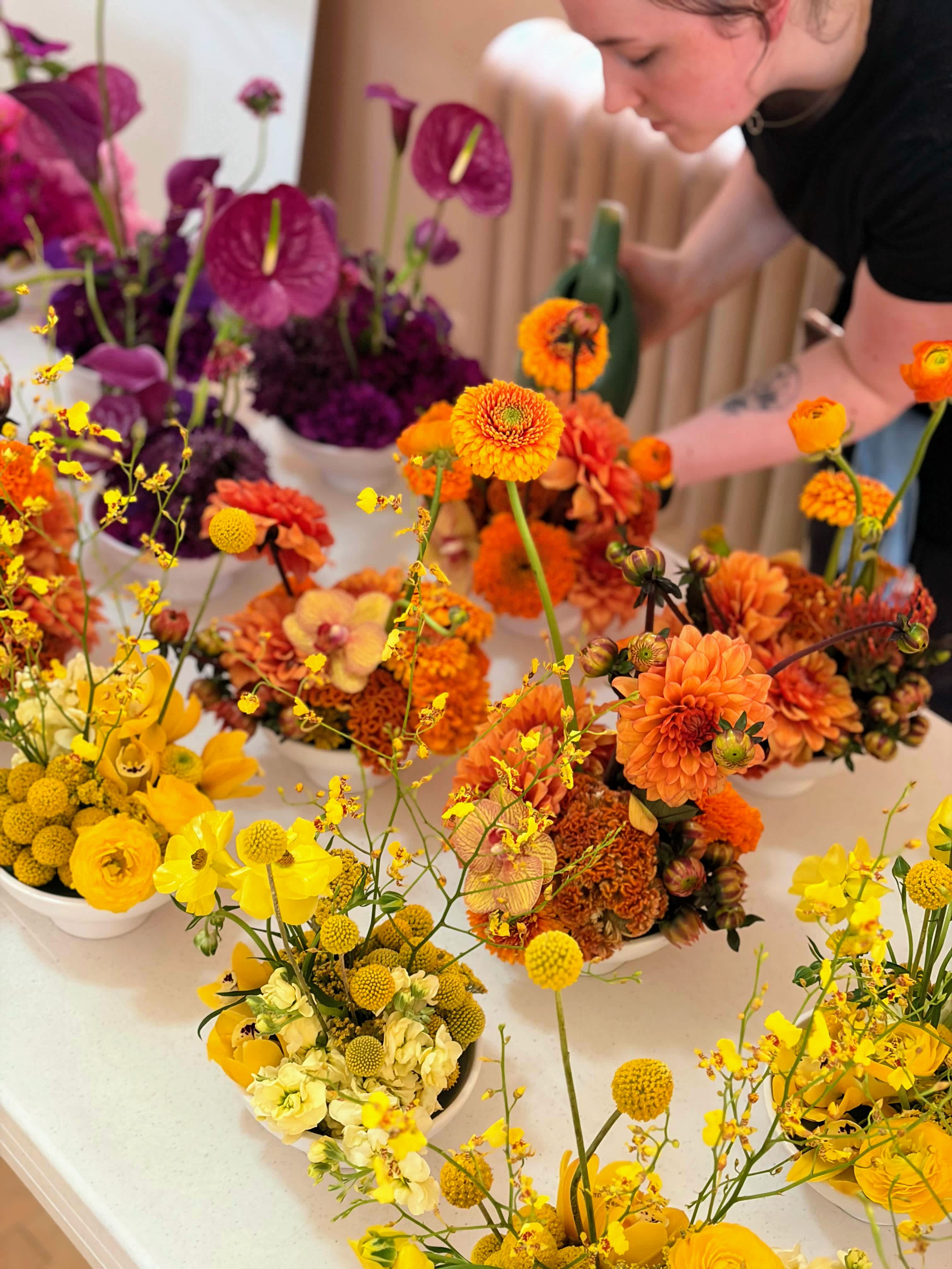 monochromatic centerpiece designs being watered by our staff member