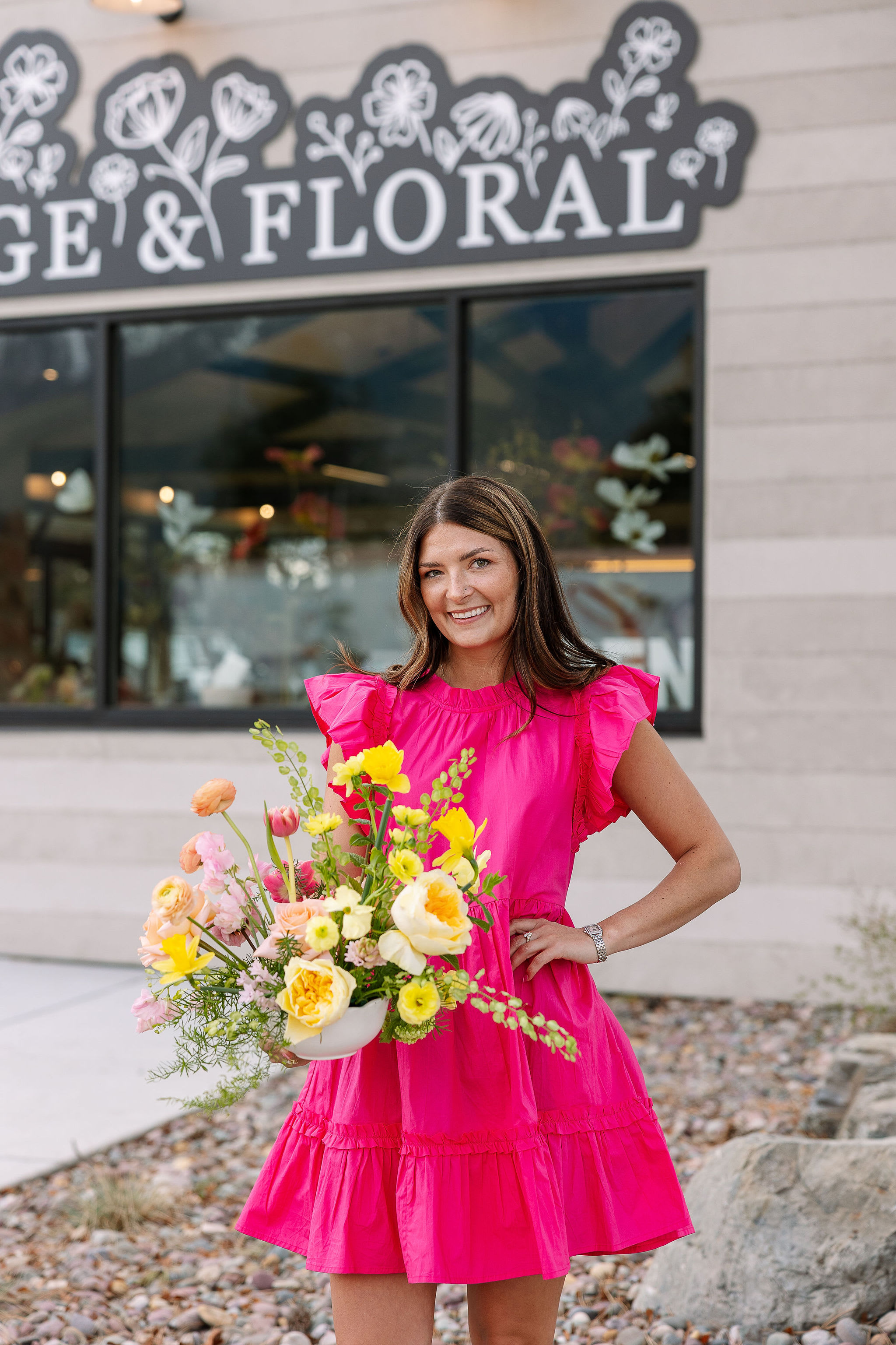 Photo of Savannah Gentry, founder, smiling and arranging a bright, cheery table arrangement