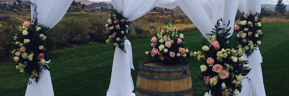 Altar with floral arragnements on posts