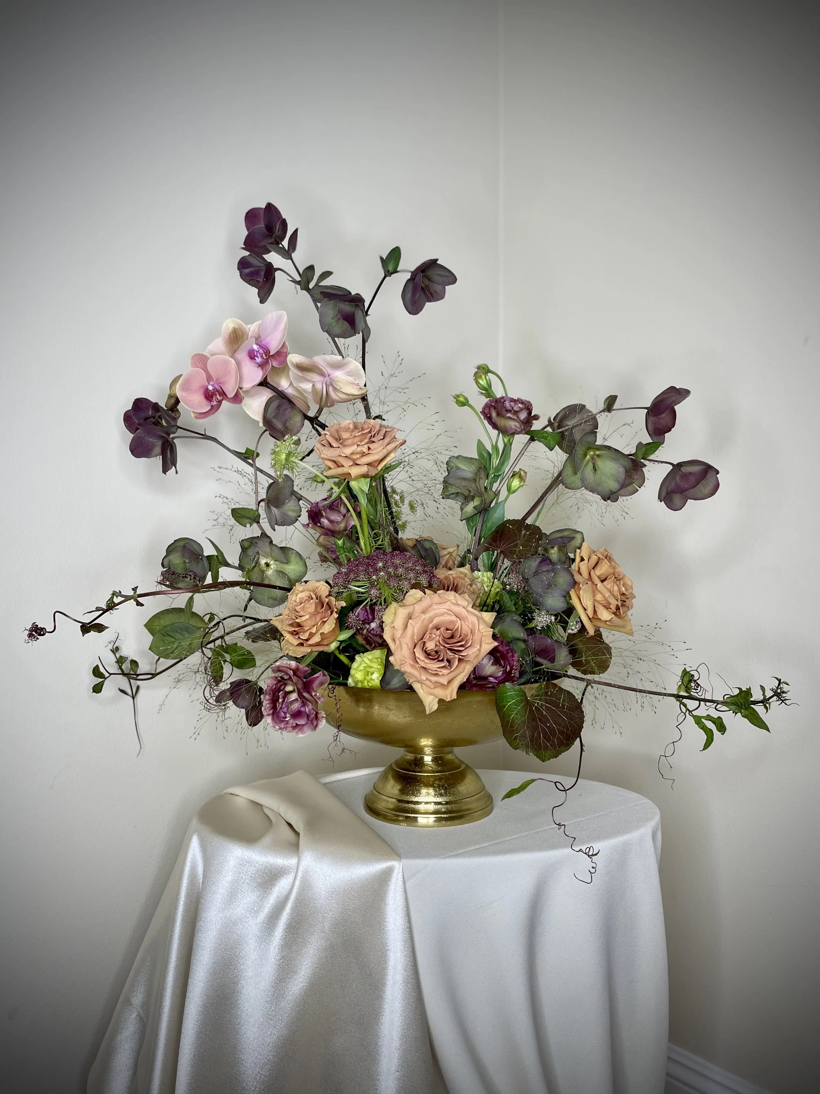 Elegant pink rose and orchid arrangement in gold vase