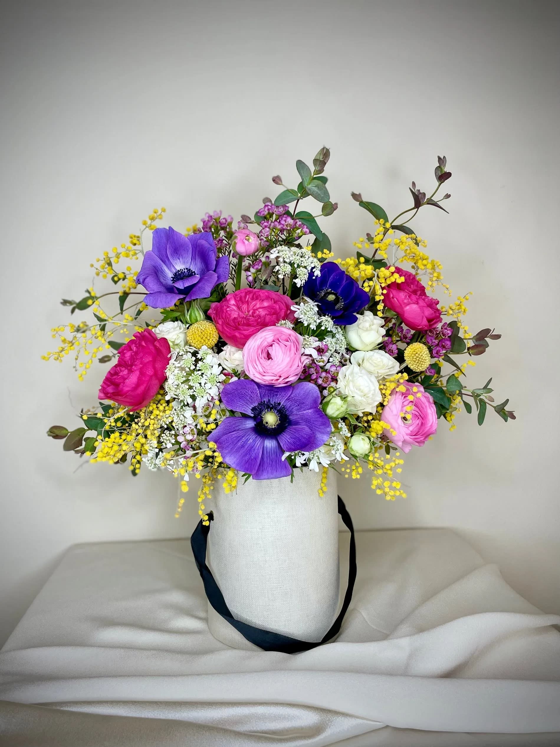 Vivid arrangement in tall clay vase