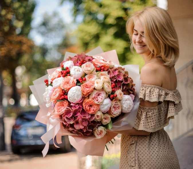 Person receiving a beautiful floral arrangement