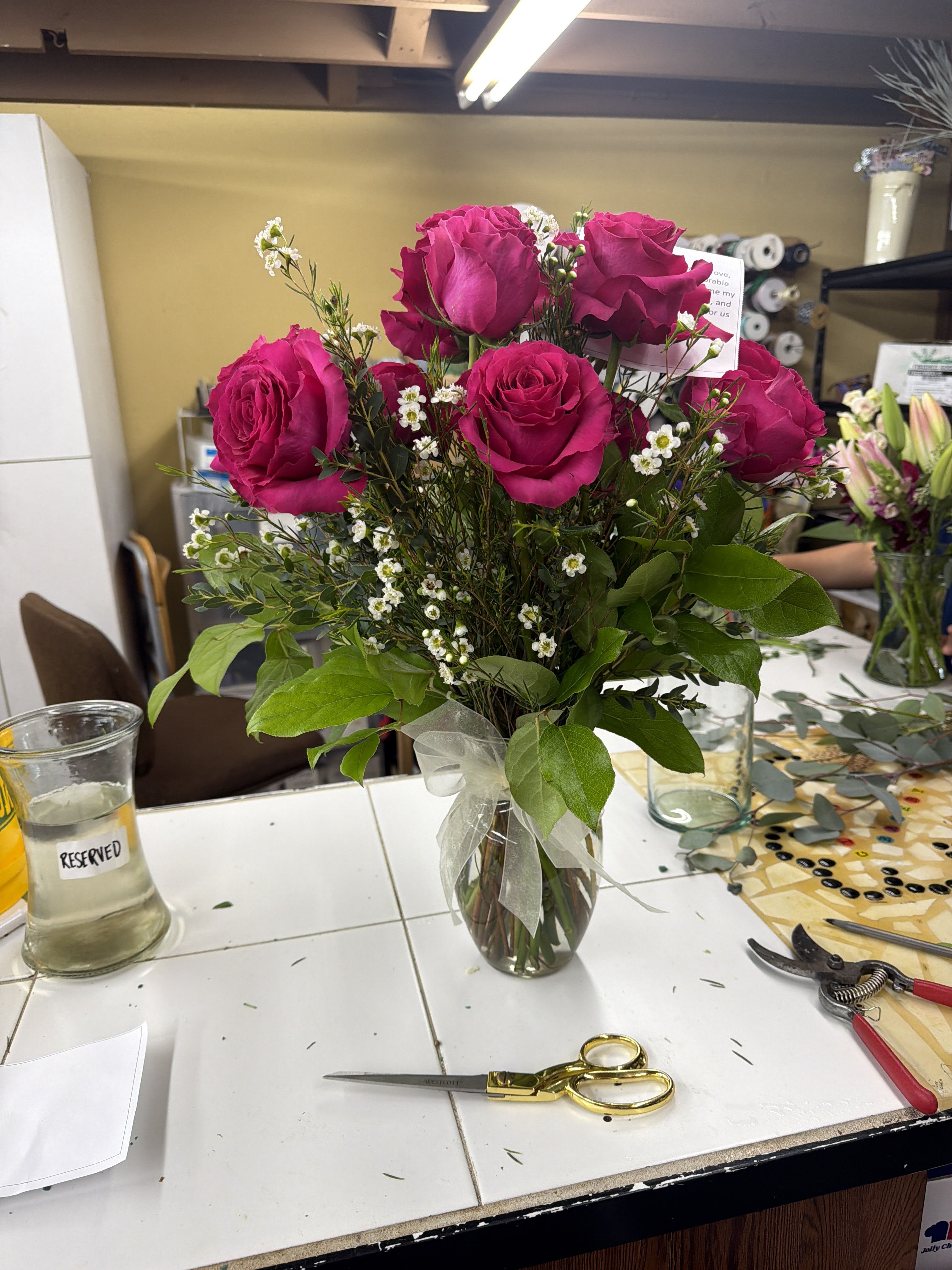 Dozen Long Stemmed Red Roses with Wax flower by BloomNation™