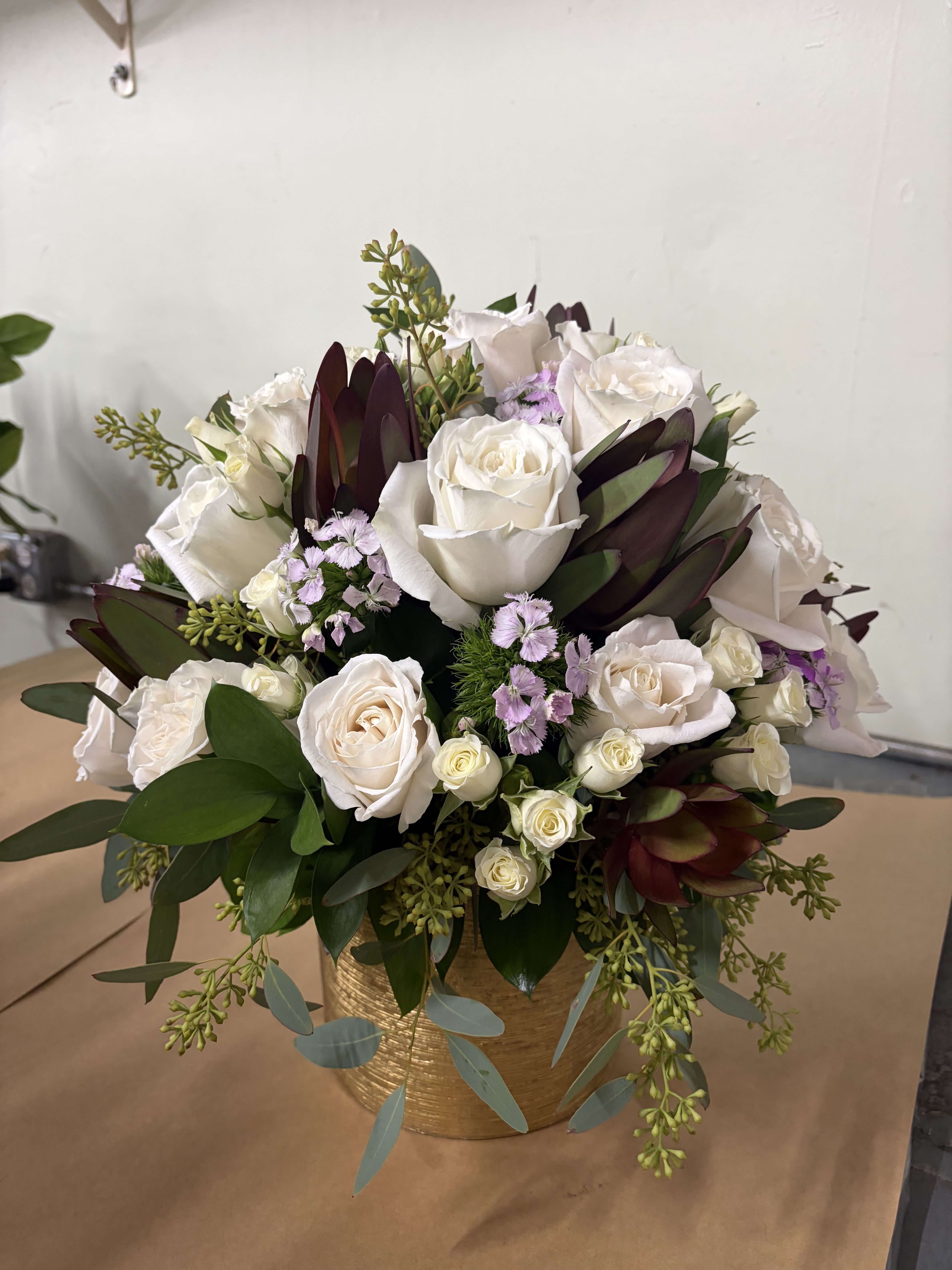 Cupid Calling – White Roses, Burgundy Leucadendron & Gold Metallic Cylinder