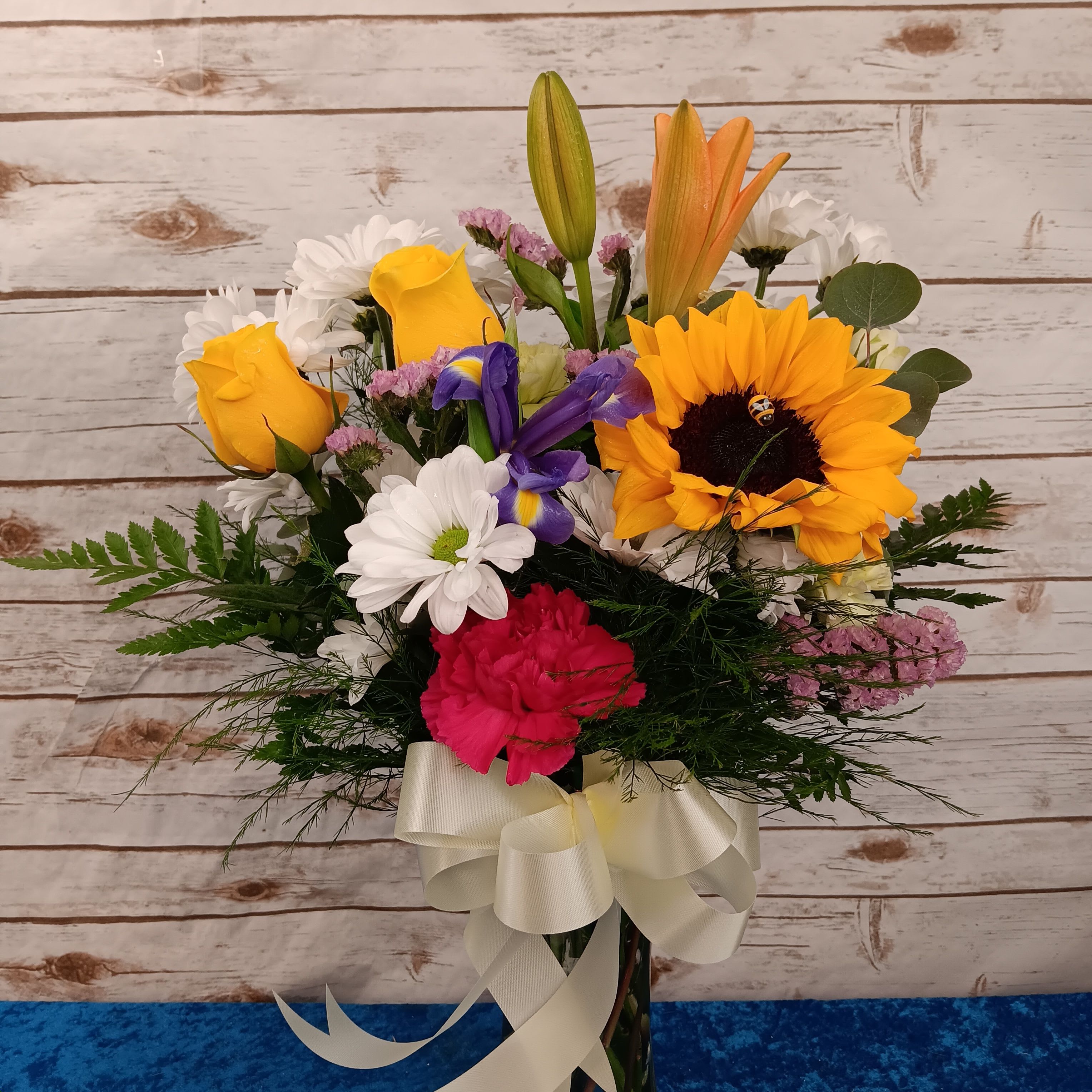 Autumn’s Gentle Glow, with lilies, golden roses, creamy white