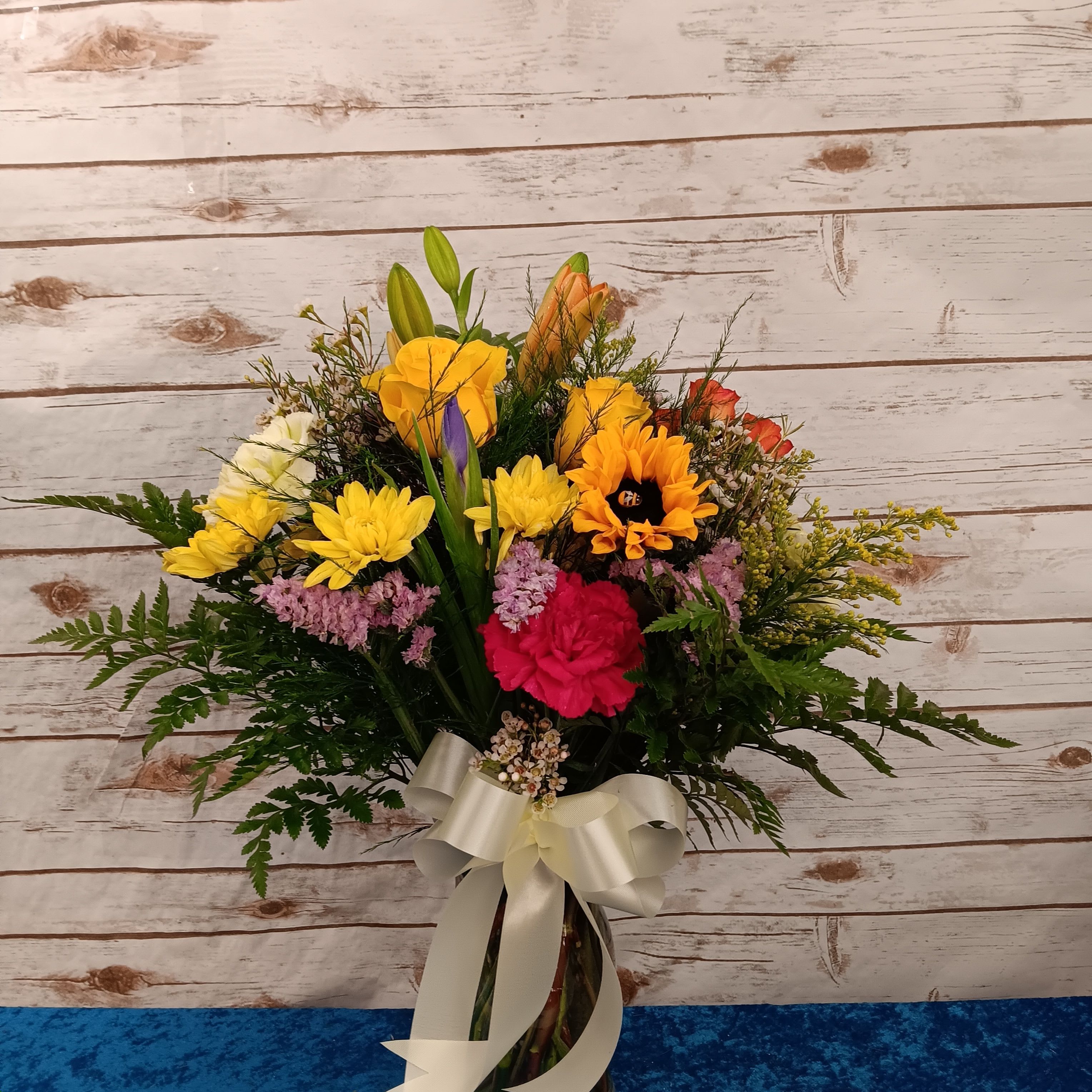 Autumn’s Gentle Glow, with lilies, golden roses, creamy white
