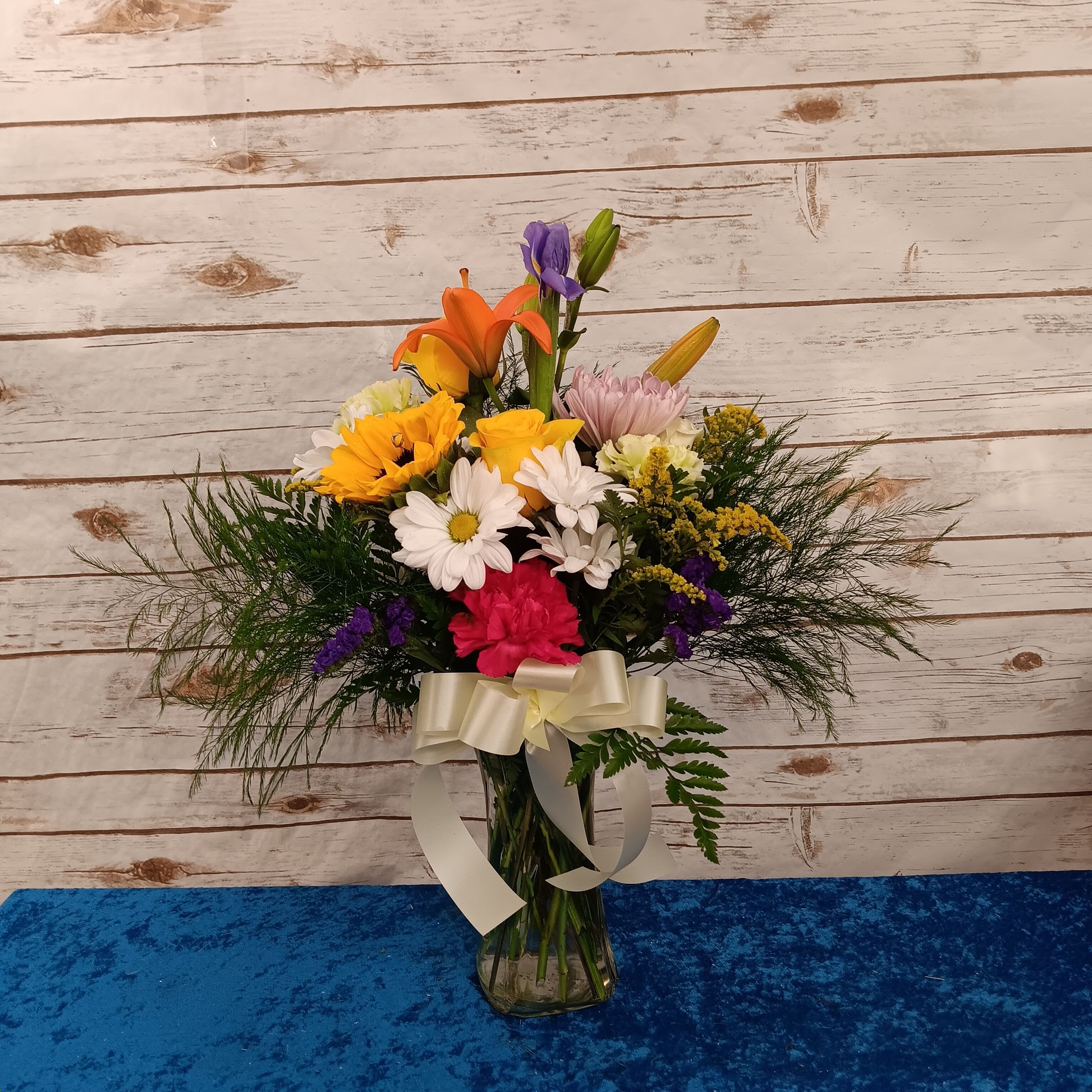 Autumn’s Gentle Glow, with lilies, golden roses, creamy white