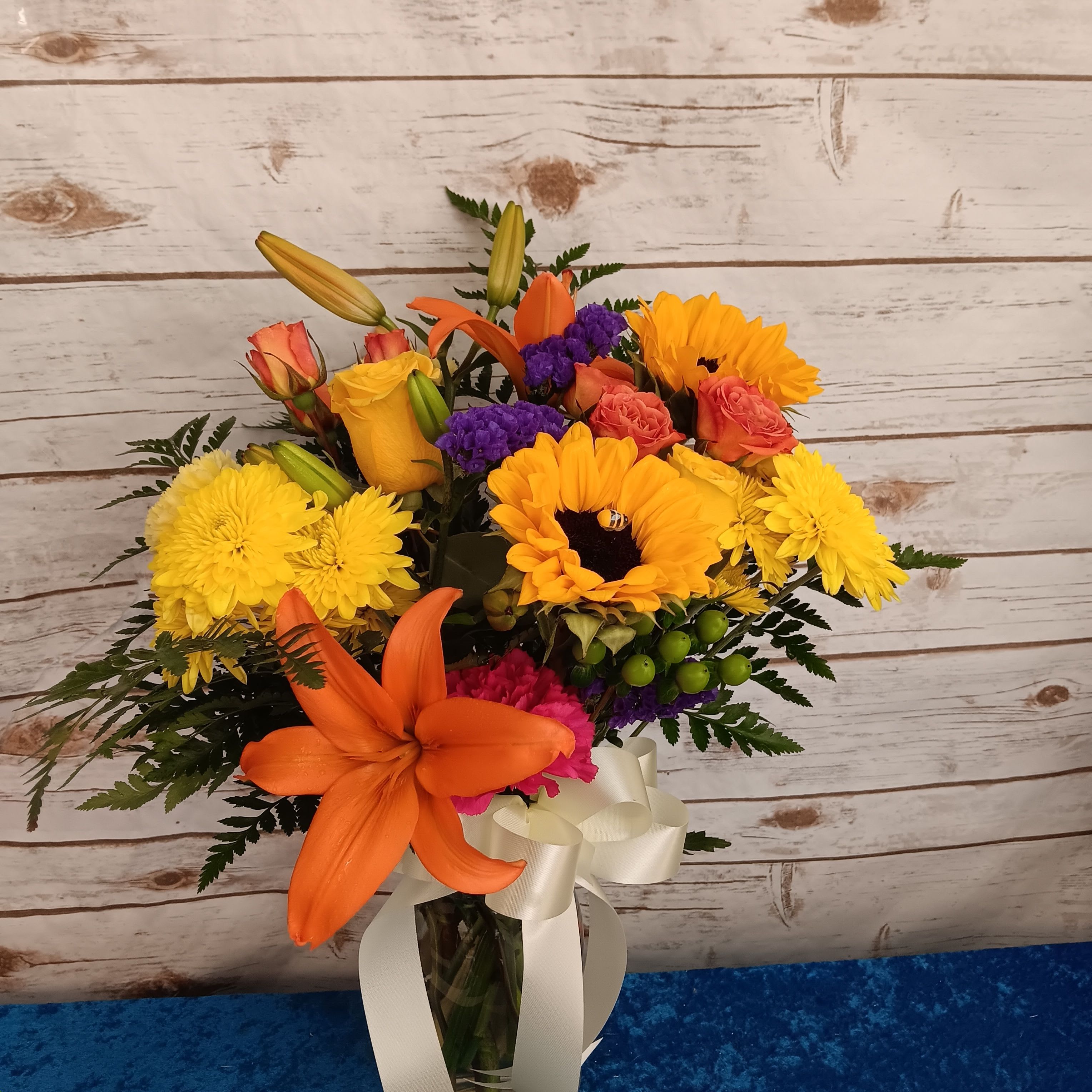 Autumn’s Gentle Glow, with lilies, golden roses, creamy white