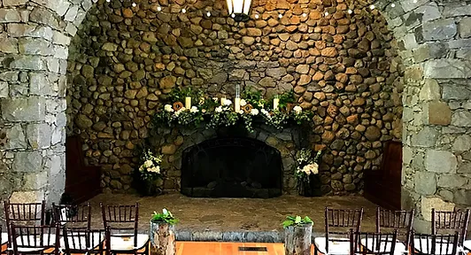 Floral arrangement on stone fireplace mantle