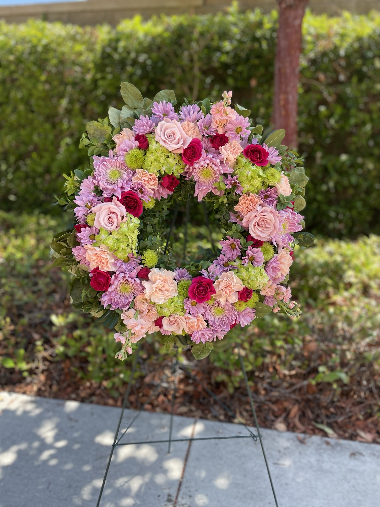 Pink and purple wreath on stand