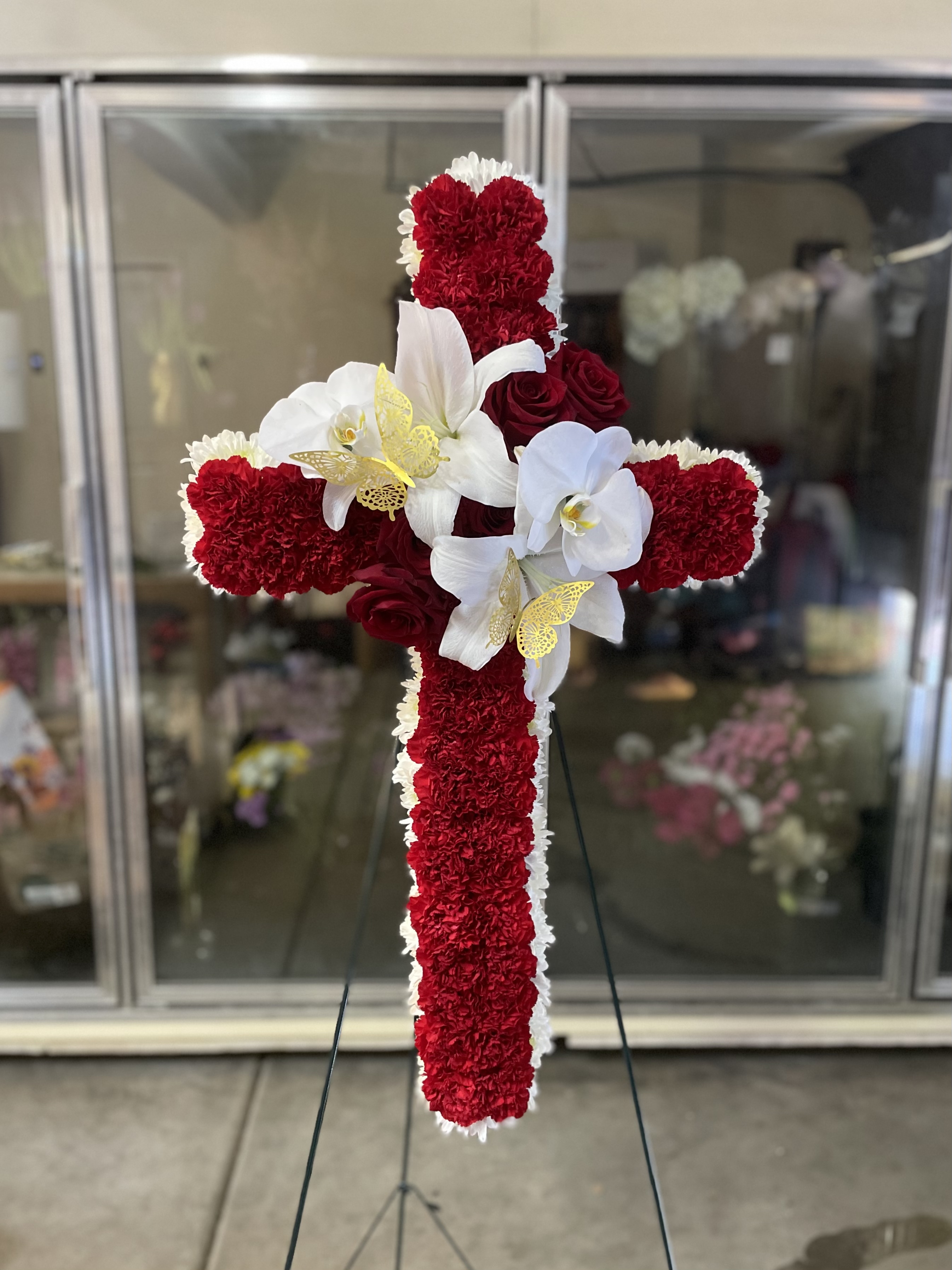 Red and white cross arrangement on stand