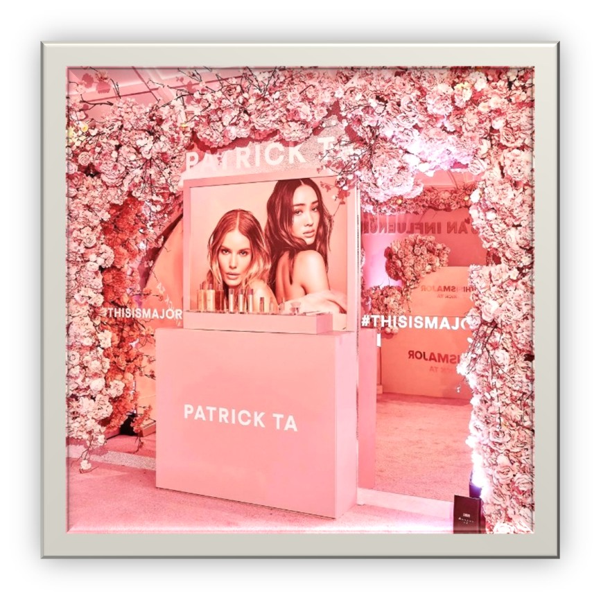 Pink brand booth with floral arch