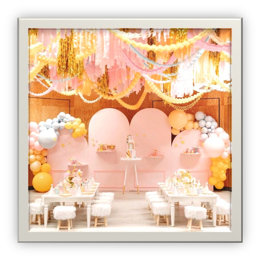 Pink and yellow event space with handing florals and centerpieces