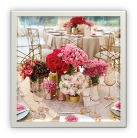 Pink clustered arrangement centerpieces in gold vases