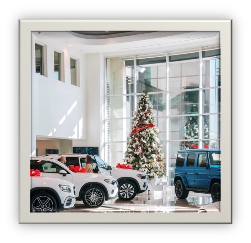 Car dealership lobby decorated with christmas trees and red ribbon