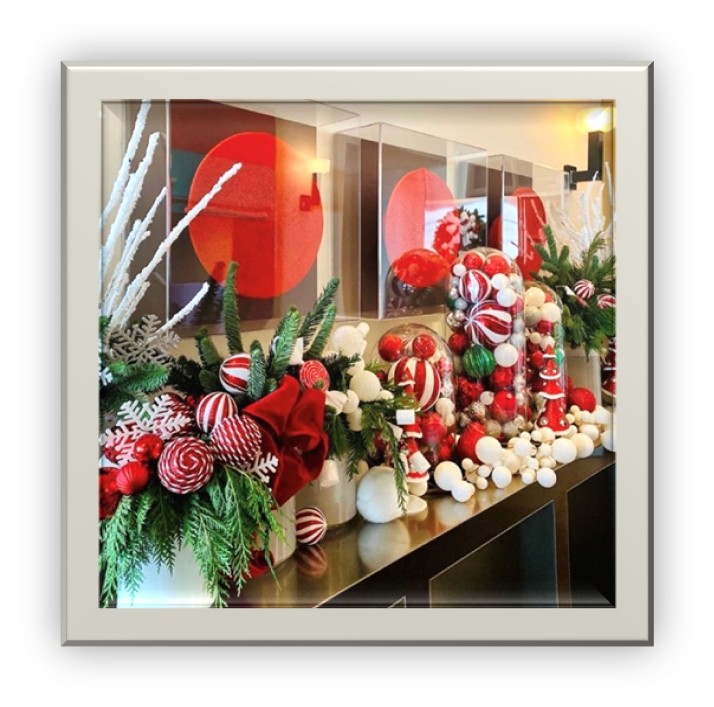 Red and white ornament arrangements on a hallway table 
