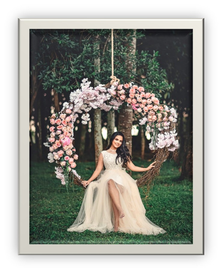 Bride on outdoor swing with florals framing it