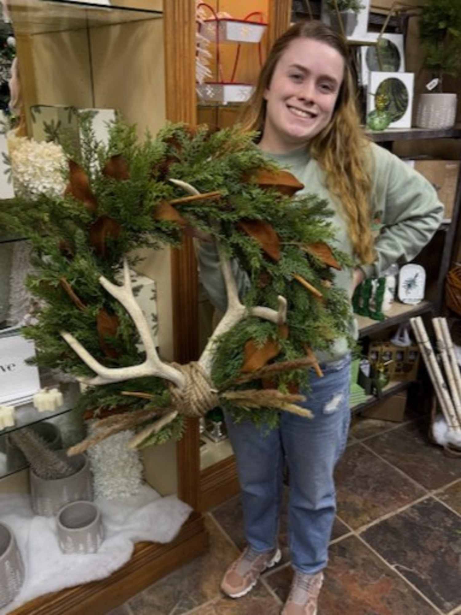 Woman holding wreath with antlers